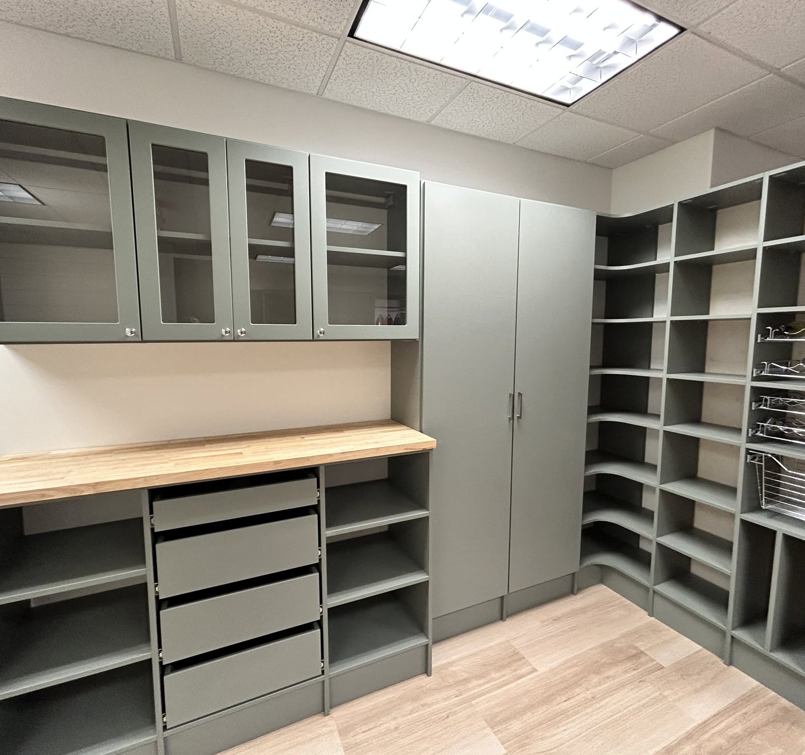 Custom pantry with organized shelving and gray cabinetry